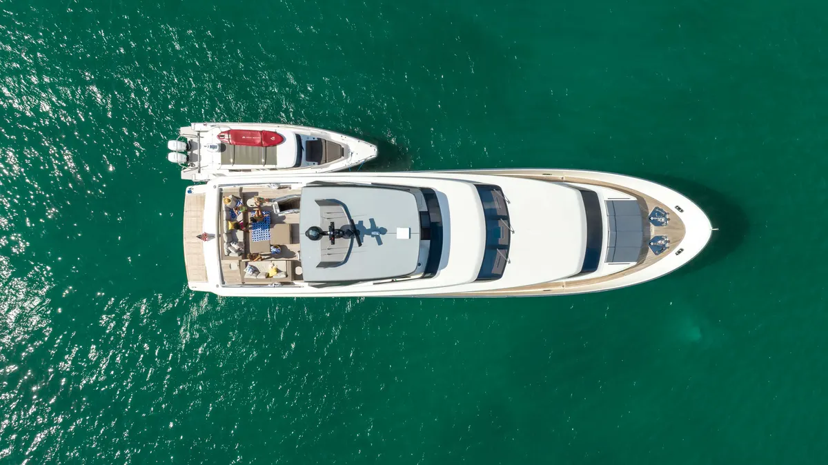 A MARE yacht under way in Biscayne Bay with the Miami skyline behind it